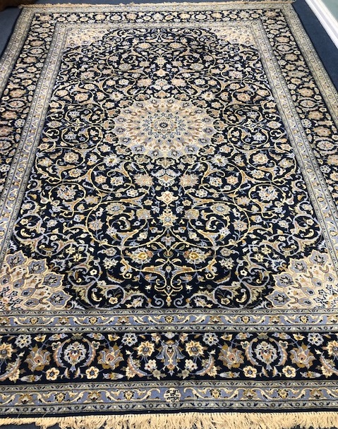 A Tabriz style blue ground carpet 388 x 279cm